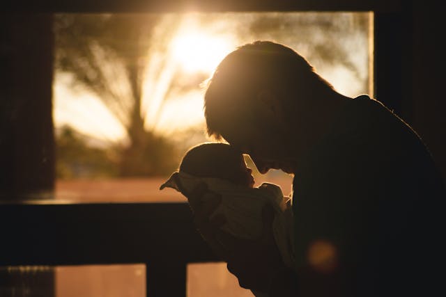 A man holding a newborn baby, representing affordable life insurance in Toronto.