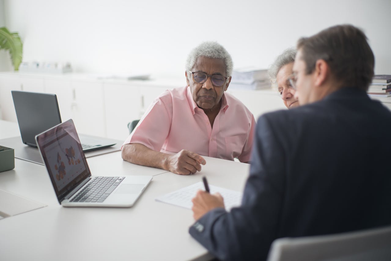 Insurance agent signing a contract with a senior couple, representing affordable life insurance in Toronto.