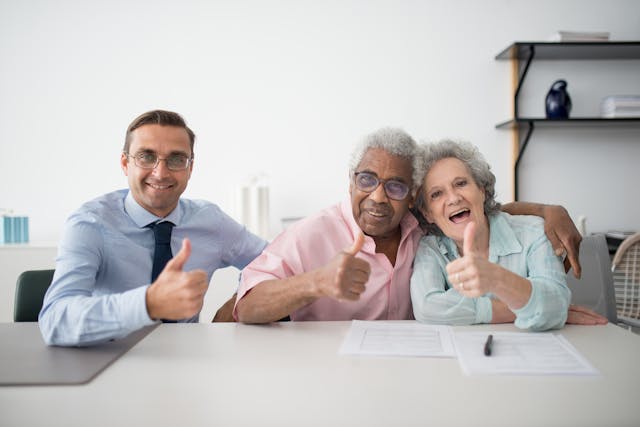 A happy senior couple signing a contract for universal life insurance, securing their financial future with Toronto universal life insurance.