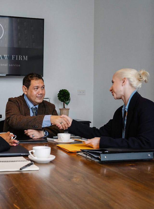 A man and woman shaking hands, making a deal on universal life insurance in Toronto.