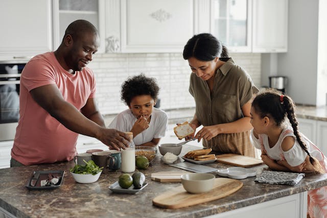 Accident and sickness insurance supporting a Toronto, Ontario family making breakfast in the kitchen