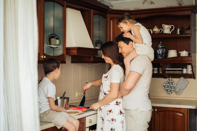 Life insurance for married couples: photo of a woman cooking near her family happy they bought a policy from Eternal Safety Insurance in Toronto, Ontario