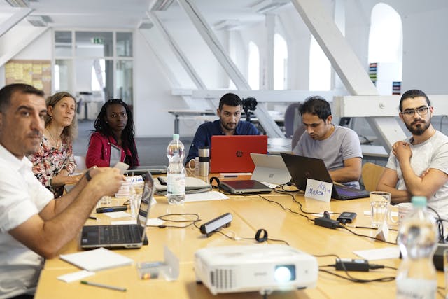 Business people in a meeting discussing employee benefits Toronto, showcasing Eternal Safety Insurance's commitment to comprehensive group benefits plans