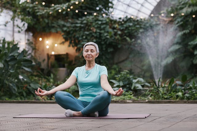 Stress-free senior lady practicing yoga in a serene environment, highlighting the peace of mind affordable long-term care insurance provides for pre-retirees.